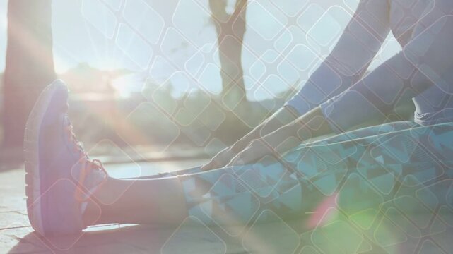 Woman stretching tying shoe on park, sun flare and grid overlay crossing legs preparing for fitness