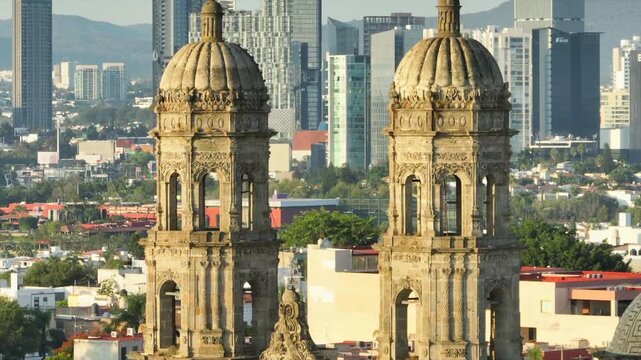 Aerial film and detail of the towers of the Catholic church in the city, background of buildings