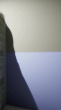 A wall in a room features a light shadow created by a computer setup. The wall has two colors, with a shadow outlining the space. The setup is near a corner of the room.