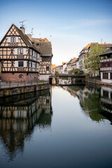 Naklejka premium Charming Waterway With Historic Houses Roof Profiles