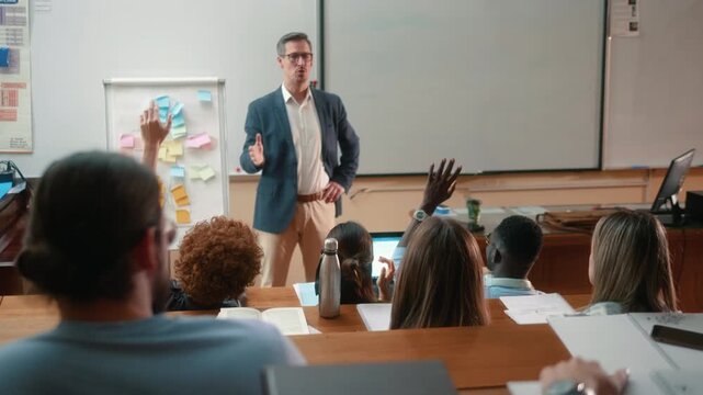 Group of diverse students raising hands after teacher question in amphitheater, captured from professor view and reverse angle showing lecture from both perspectives.