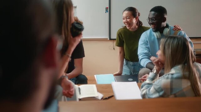 Relaxed diverse university students chatting and laughing in amphitheater during break. Friendly social atmosphere, campus life and casual interaction between classmates.