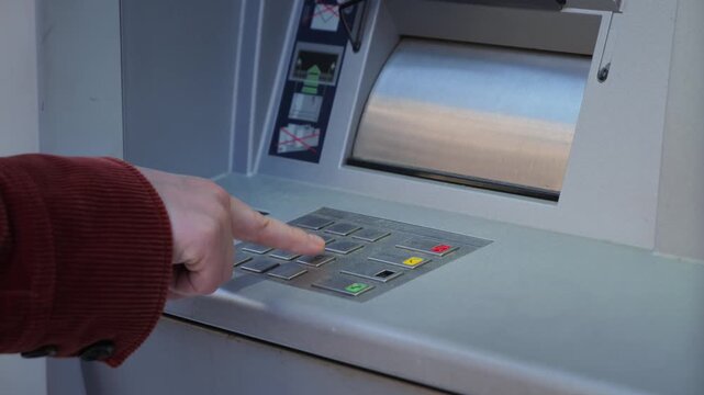 A close-up of a hand entering a PIN on an ATM keypad. The scene showcases banking security, financial authentication, and modern cash withdrawal processes, with an emphasis on technology and user