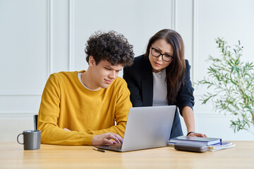 Fototapeta premium Confident female mentor teacher advising teaching male university student