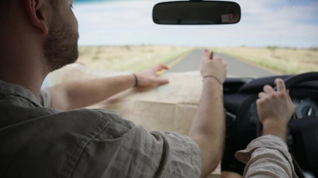 Adventurous traveler navigating road trip through vast desert landscapes of Namibia, Africa, consulting a map to find best route to destination