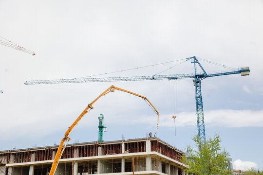 Construction Site with Cranes and Concrete Pump Building Progress and Urban Development