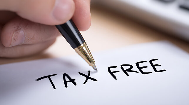 A hand holds a pen, poised to write "TAX FREE" on a pristine white paper, symbolizing financial exemption and savings on purchases