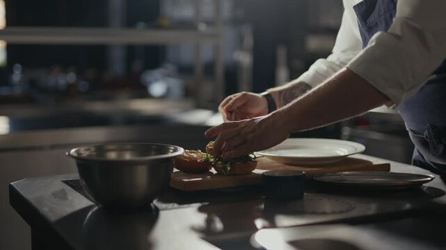 Hands shape food on a wooden board. Soft lighting highlights the chef's focused action. Kitchen tools rest nearby, unused. The mood is calm and skilled. Perfect for food prep or restaurant branding