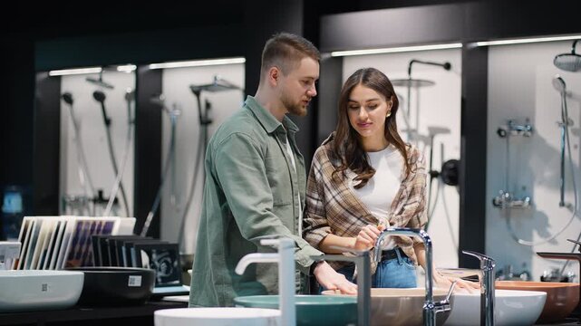 Happy young couple choosing bathroom fixtures together