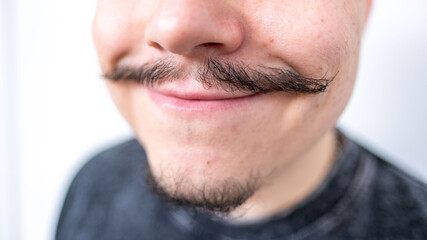 Fototapeta premium Portrait middle-aged man with elegant mustache smiling cheerfully, Positive energy and optimism, Authentic male humor, expressing joy and confidence, happiness, charisma, and positive emotions