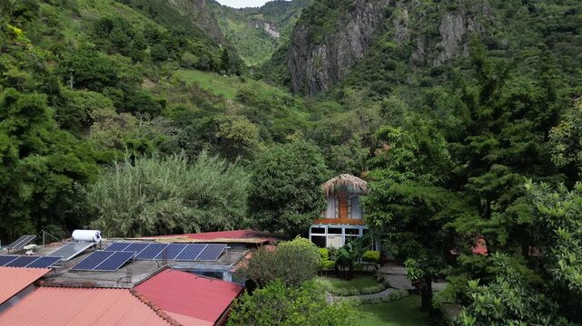 aerial drone view rising over home on lake atitlan guatemala with volcano mountains in the background caldera latin america hotel villa town village santa cruz