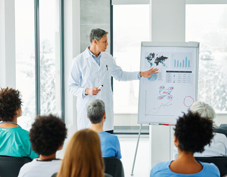 Portrait of a young doctor teaching on a seminar in a board room or during an educational class at convention center