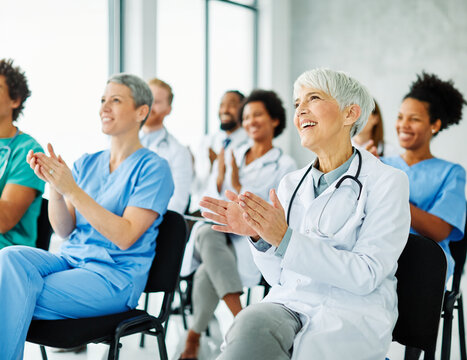 Portrait of a young doctors and nurses in audiance during a seminar in a board room or during an educational class at convention center