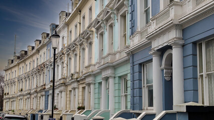 Fototapeta premium London, UK; 15th February 2026: Colourful Victorian terraced houses in Notting Hill, showcasing the neighbourhood's iconic pastel architecture at sunset
