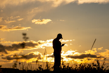 Man against the backdrop of the sunset sky in a field © Eugeniusz