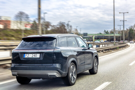 Black SUV driving on a high speed highway. Modern crossover moving along the road.