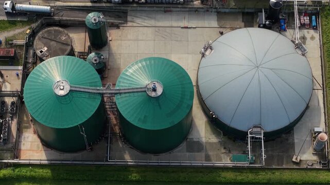 Aerial view of Bioganix Ltd industrial facility featuring large green and grey storage tanks and silos in Brigg, England, United Kingdom.