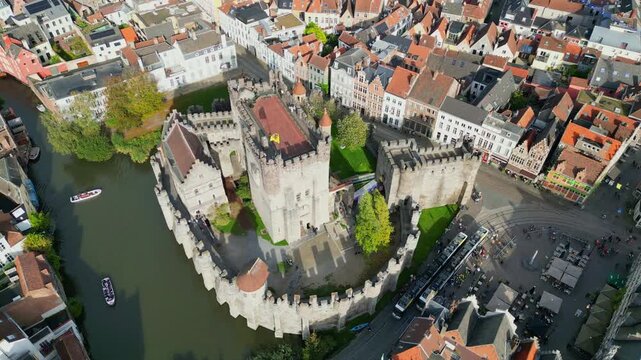 Aerial drone shot of the 10th-century Gravensteen Castle (Castle of the Counts) in Ghent, Belgium. Iconic medieval fortress with its moat and towers in the historic city center.
