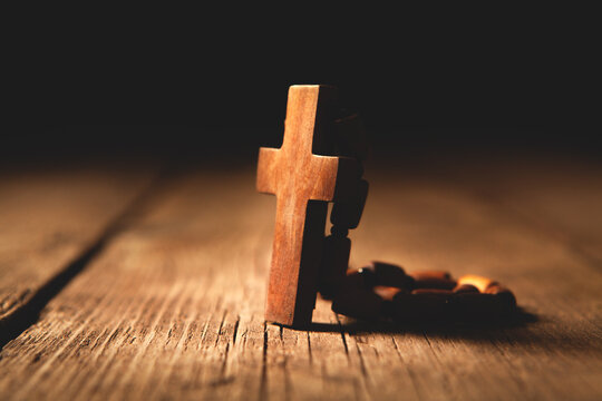 Wooden cross on a wooden background. Christian symbols. Religion concept.