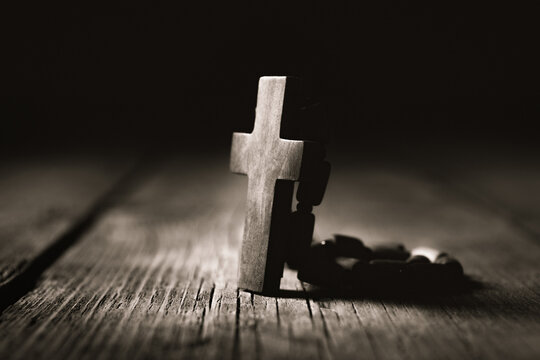 Wooden cross on a wooden background. Christian symbols. Religion concept.