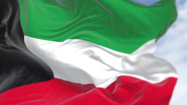 Kuwait national flag waving in the wind. Horizontal bands of green, white, and red, with a black trapezoid on the left side. Seamless 3d render animation. Slow motion loop. Selective focus