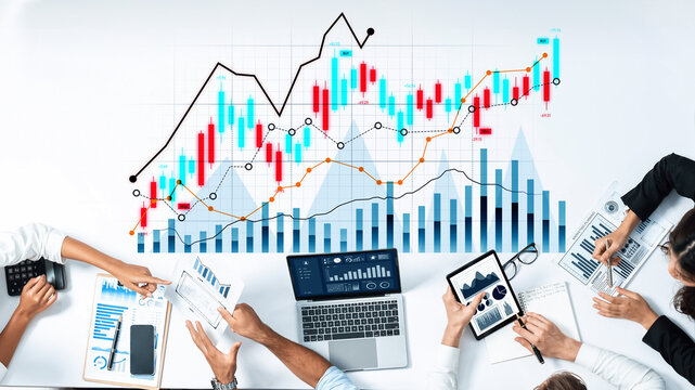 A diverse group of professionals collaboratively analyzing financial data and trends using laptops and tablets in a modern office, enhancing productivity and insights. Scalp