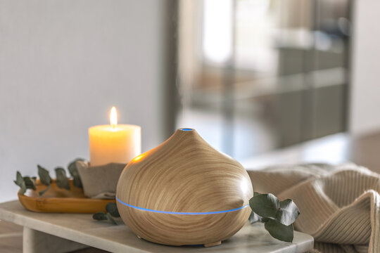 Aroma diffuser in modern minimal interior creating relaxing wellness atmosphere. Home spa diffuser.
