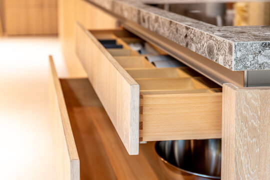 Modern kitchen interior with a wooden drawer. Design detail of a high-quality kitchen island.