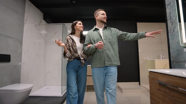 Young couple choosing bathroom fixtures in showroom