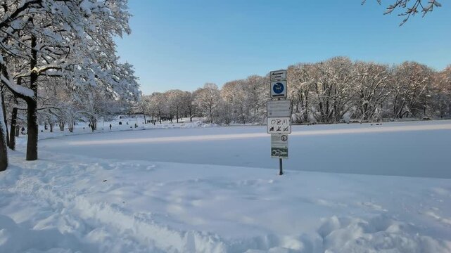 Winter Landscape of English Garden Munich with Ice Safety Sign for Editorial Content