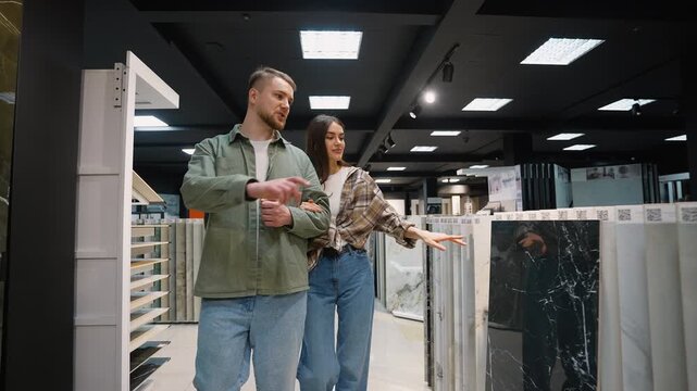 Young couple shopping for tiles in a hardware store