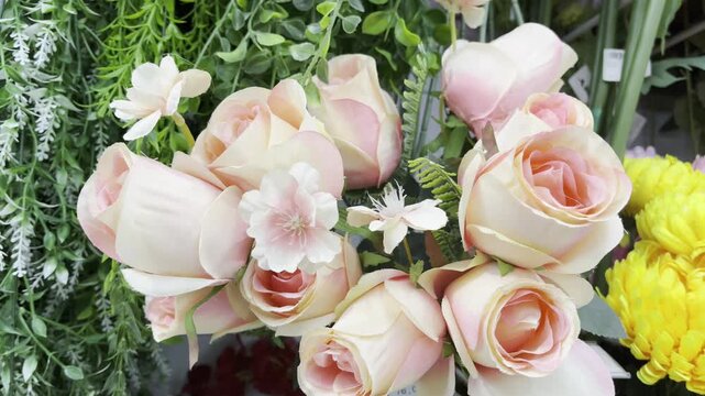 Close up of pink and peach roses in a blooming bouquet