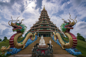 Fototapeta premium Giant white Guanyin statue and pagoda at Wat Huay Pla Kang temple in Chiang Rai, Thailand