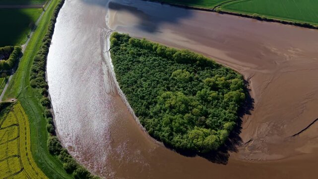Aerial view of Howden Dyke Island surrounded by the silty brown waters of the River Ouse Goole, England, United Kingdom.