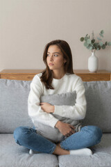 Fototapeta premium Thoughtful Woman on Sofa