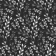 Seamless repeating pattern features delicate branches with multiple leaves in shades of white and gray. The foliage stands out against a dark black background, creating an elegant monochrome design. © okskukuruza
