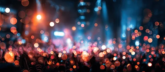 A vibrant concert scene is captured with a bokeh effect, showcasing the energy of a live performance. © nurlela