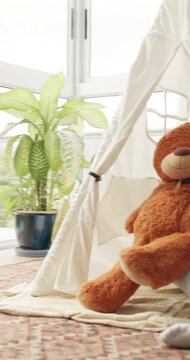 Face, girl and teddy bear hug with tent in home for child development, fantasy or playful game. Embracing, smile and stuffed animal with happy kid playing in apartment for comfort, fun or growth