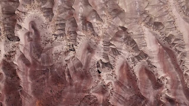 Aerial view of the eroded ridges and colorful sediment layers of the Little Painted Desert landscape near Winslow, Arizona, United States.