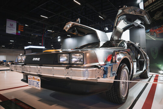 DeLorean DMC-12 vehicle with brushed stainless steel body, gull-wing doors, and two-seat coupe configuration.