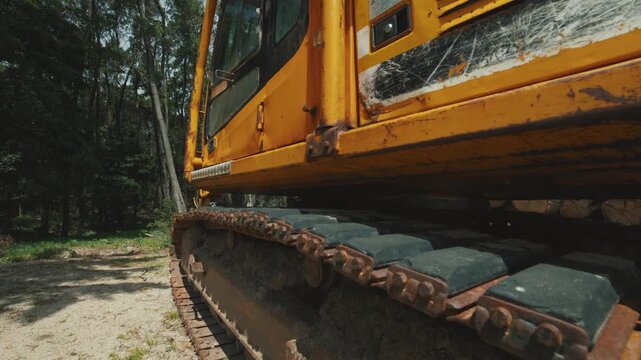 Heavy machinery excavator crawler parked in forest