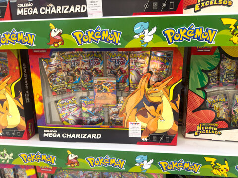 BELO HORIZONTE, MG, BRAZIL, APRIL 11, 2026 A "Cole&ccedil;&atilde;o Mega Charizard" Pok&eacute;mon Trading Card Game box set, packed with booster packs and special cards, is neatly presented on a store shelf.