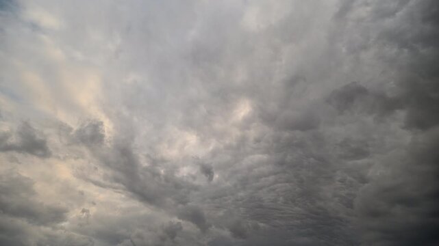 Opposite clouds drift with tension. Sky scenes showing contrasting swirling clouds. Wideangle sky sequence capturing opposing cloud flows and moody atmospheric shades