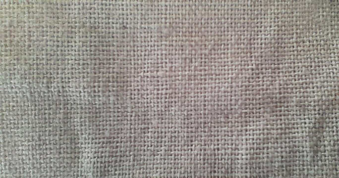 Close up of natural burlap fabric texture, brown hessian cloth background.