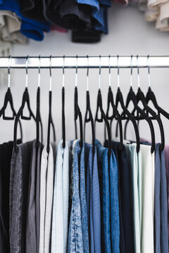 women trousers jeans and yoga pants in decluttered organized wardrobe