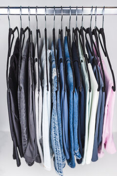 women trousers jeans and yoga pants in decluttered organized wardrobe