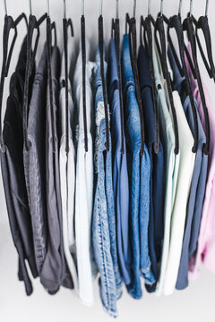 women trousers jeans and yoga pants in decluttered organized wardrobe