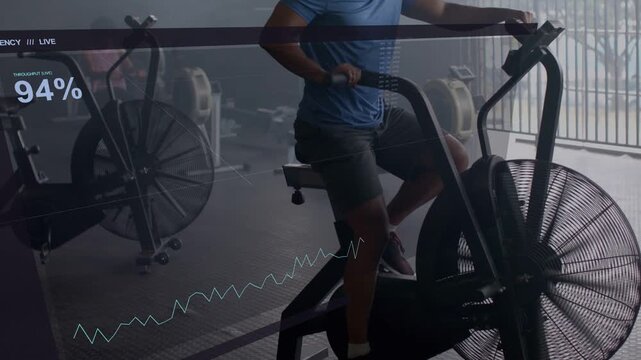 Man on air bike in gym pedaling, initiating HUD 94% tracking while gripping handles, driving fan