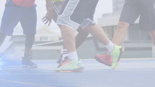 Men dribbling ball on blue sports court, neon shoes drawing defenders, blue flare marking footwork