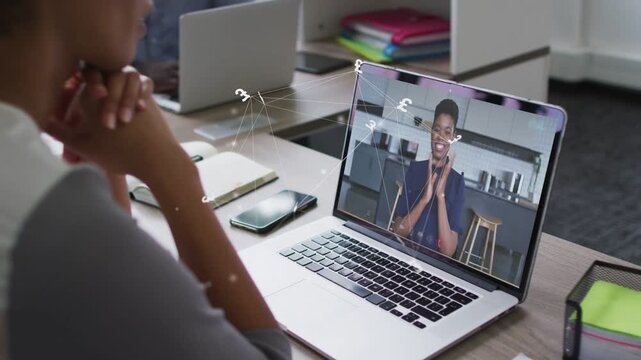 Worker watching laptop on team call host gesturing animated lines linking items highlighting points